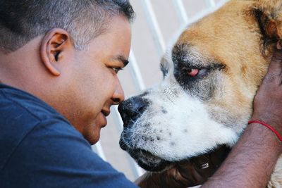 Close-up of man looking at dog