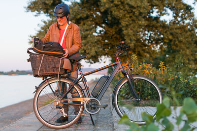 Man standing in front of electric bicycle