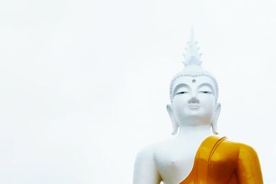 Low angle view of buddha statue against clear sky