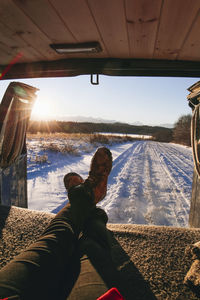 Low section of woman sitting in vehicle during winter