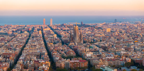 Aerial view of cityscape against sky during sunset