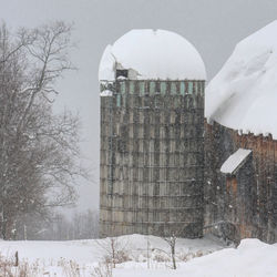 Snow covered field by building