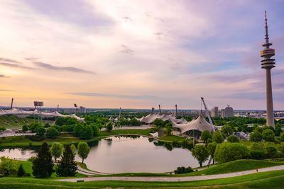 Scenic view of river and buildings against sky during sunset