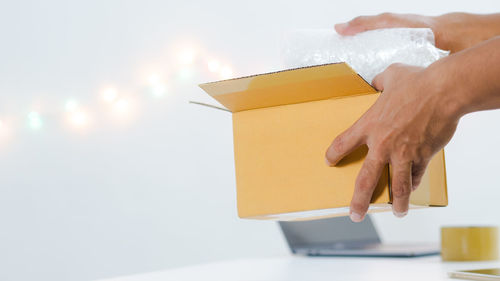 Close-up of hand holding paper with box