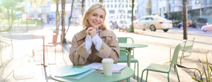 Young woman using mobile phone in cafe