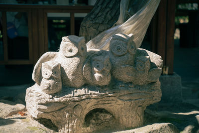 Close-up of statue of owls
