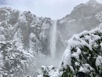 Scenic view of waterfall on snow covered land