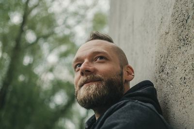 Man with spiky hair against wall