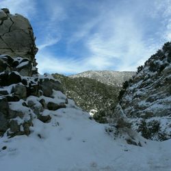 Scenic view of mountains against cloudy sky