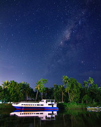 Scenic view of lake against sky at night