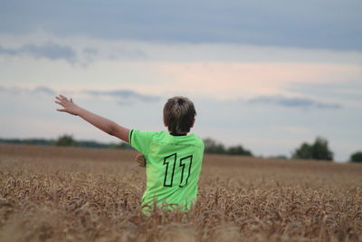 Rear view of child in the field