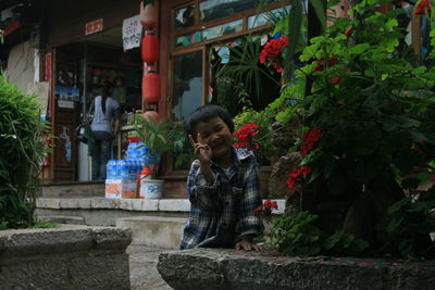 Portrait of boy showing thumbs up