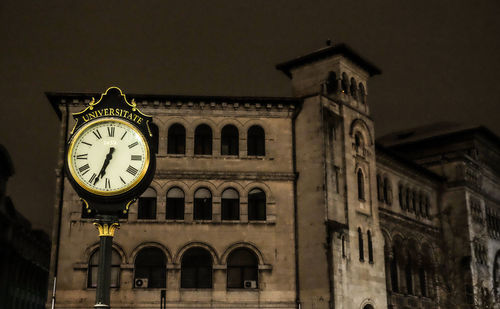 Low angle view of clock tower against sky