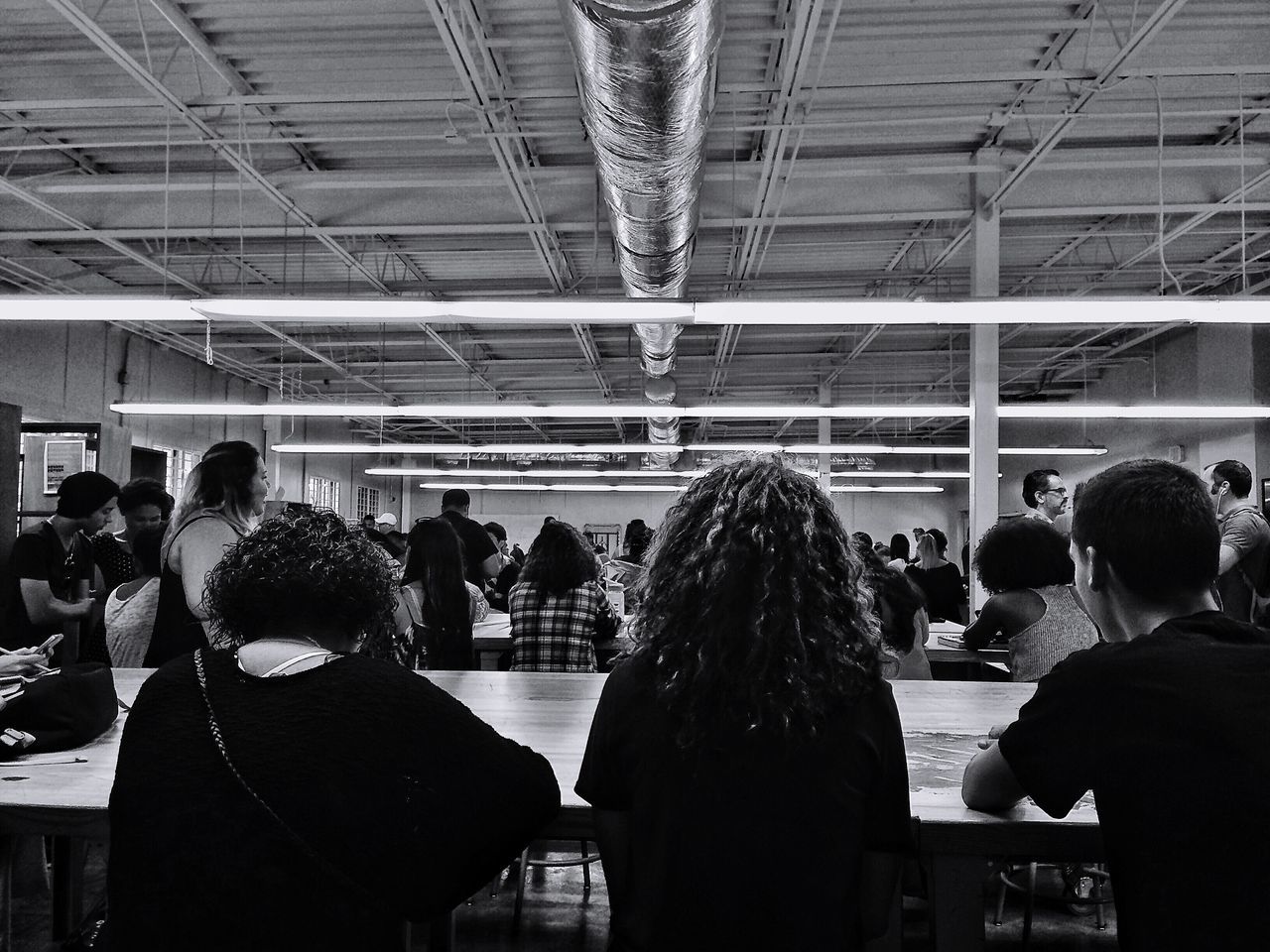 REAR VIEW OF PEOPLE STANDING IN SUBWAY STATION