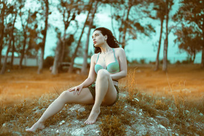 Full length of woman on field against trees