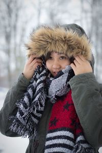 Young woman in warm clothing looking away during winter
