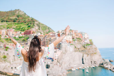 Rear view of woman looking at sea against sky
