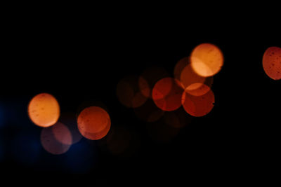 Defocused image of lights against sky at night