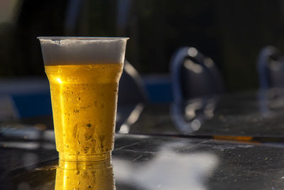 Close-up of beer glass on table