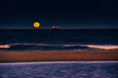 Scenic view of sea against sky at night