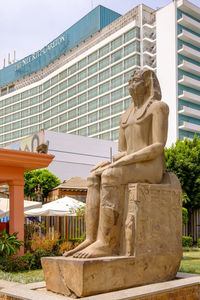 Statue against buildings in city