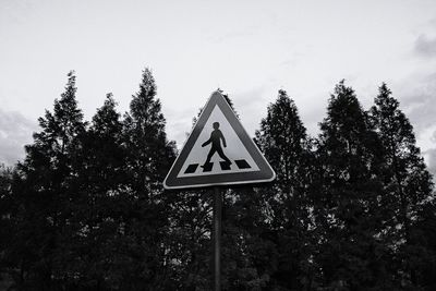 Low angle view of road sign against sky