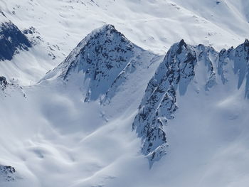 Aerial view of snow covered mountain against sky