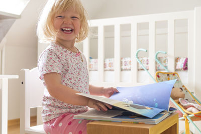 Portrait of happy girl with book