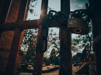 Close-up of padlocks hanging on rusty metal