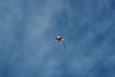 Low angle view of airplane flying against sky