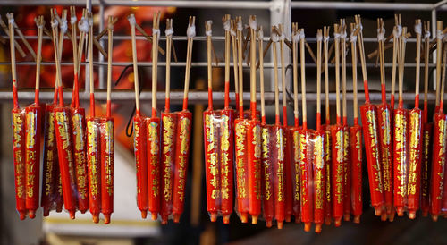 Closeup of chinese style red candles with golden blessing words hanging upside down.
