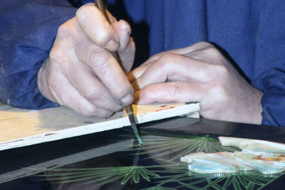 Close-up of man holding hand