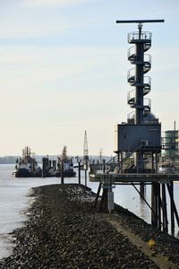 Pier at harbor against sky