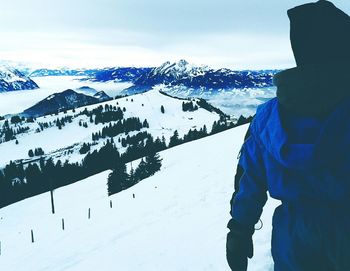 Woman standing on snow covered mountain