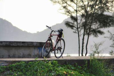 Bicycle on field against sky