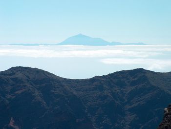 Scenic view of mountains against cloudy sky