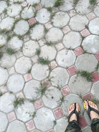 Low section of person standing on cobblestone