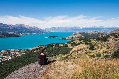 Rear view of woman looking at view against sky