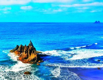 Scenic view of sea against blue sky