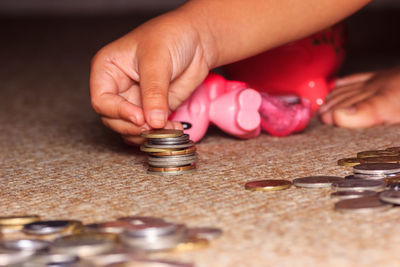 Cropped hand of person stacking coins