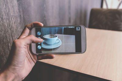 Midsection of man using mobile phone