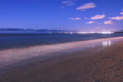 Scenic view of beach against blue sky