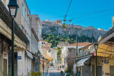 Buildings in town against clear blue sky