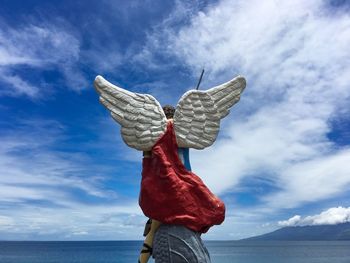 Low angle view of umbrella against sea against sky