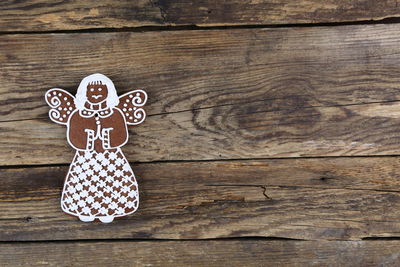 Close-up of christmas gingerbread cookie on wooden surface