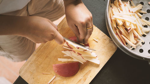 High angle view of woman preparing food on cutting board