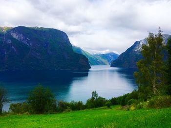 Scenic view of lake and mountains against sky