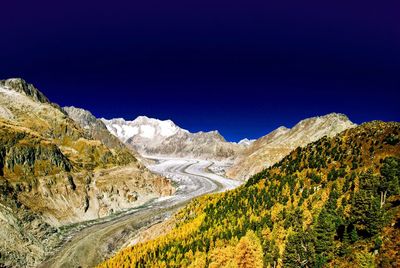 Scenic view of mountains against clear blue sky