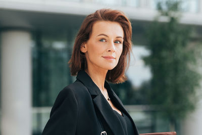 Portrait of young woman standing outdoors