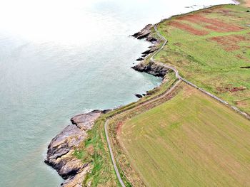 Aerial view of cliff by sea against sky